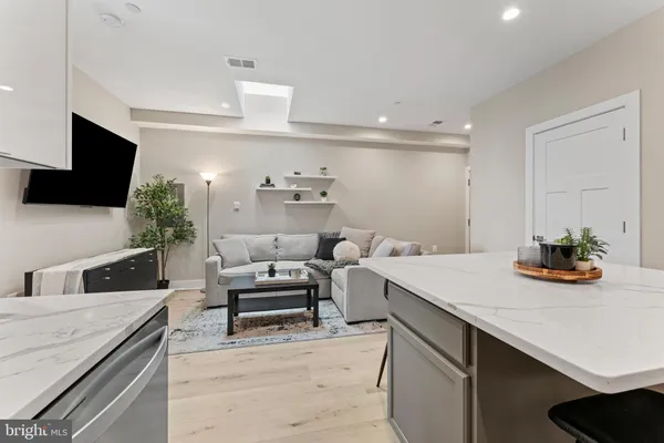 a kitchen with a sink cabinets and wooden floor