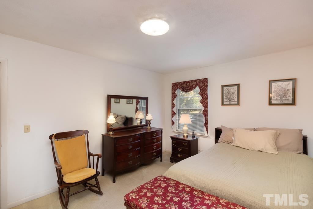 6913 Electra Drive Raleigh, NC 27607 - Photo 22 of 30 a bedroom with a bed and a desk