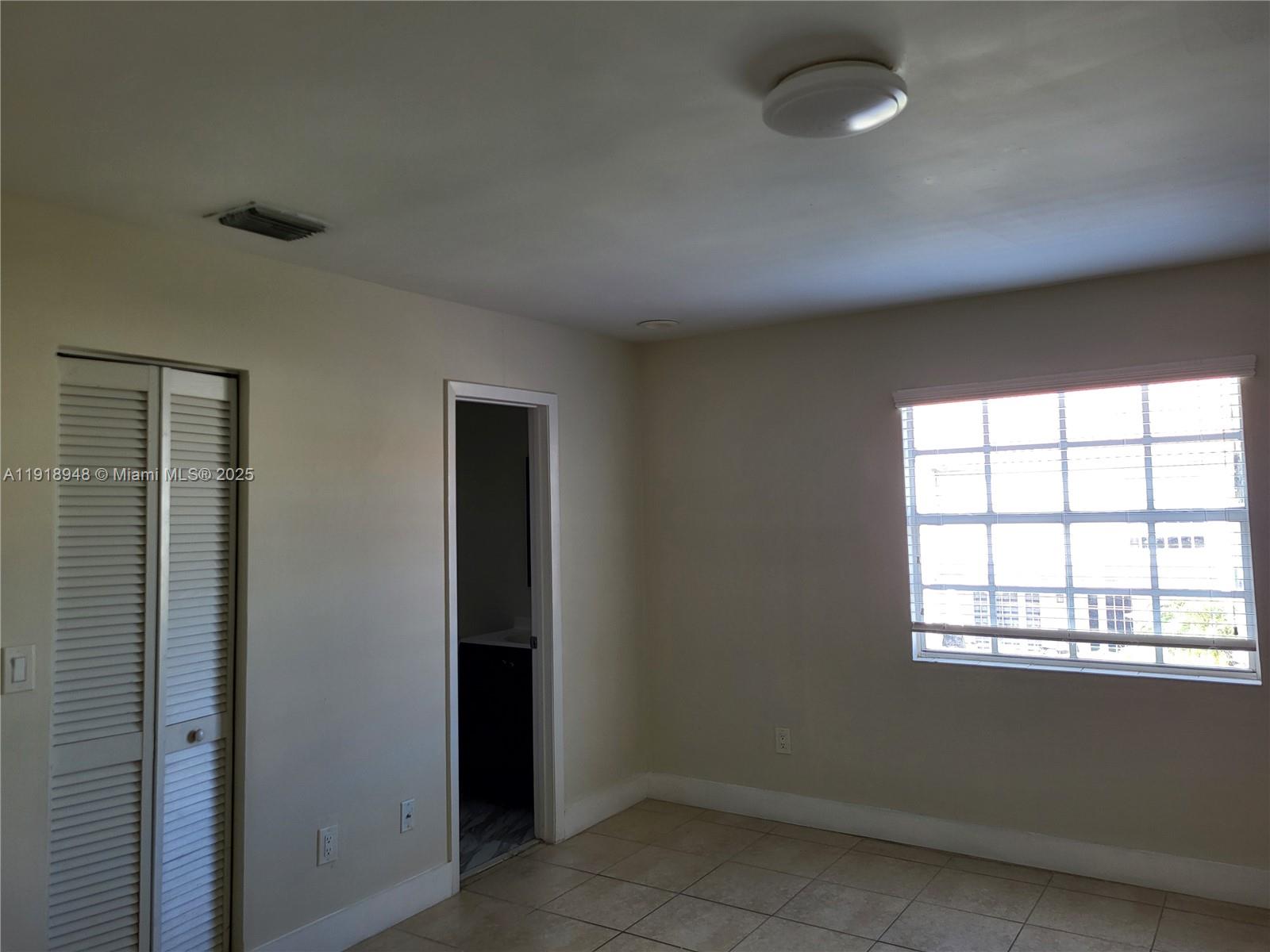 12309 Southwest 250th Street Homestead, FL 33032 - Photo 15 of 26 an empty room with a empty space and windows