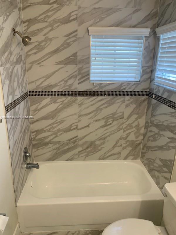 12309 Southwest 250th Street Homestead, FL 33032 - Photo 16 of 26 a bathroom with a bathtub and a window