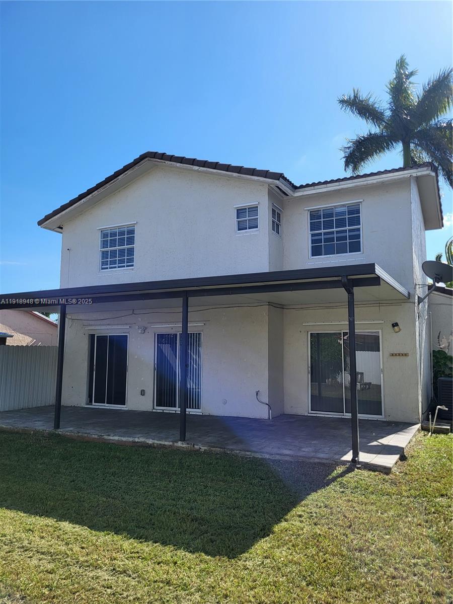 12309 Southwest 250th Street Homestead, FL 33032 - Photo 24 of 26 a view of a house with a yard and a fireplace