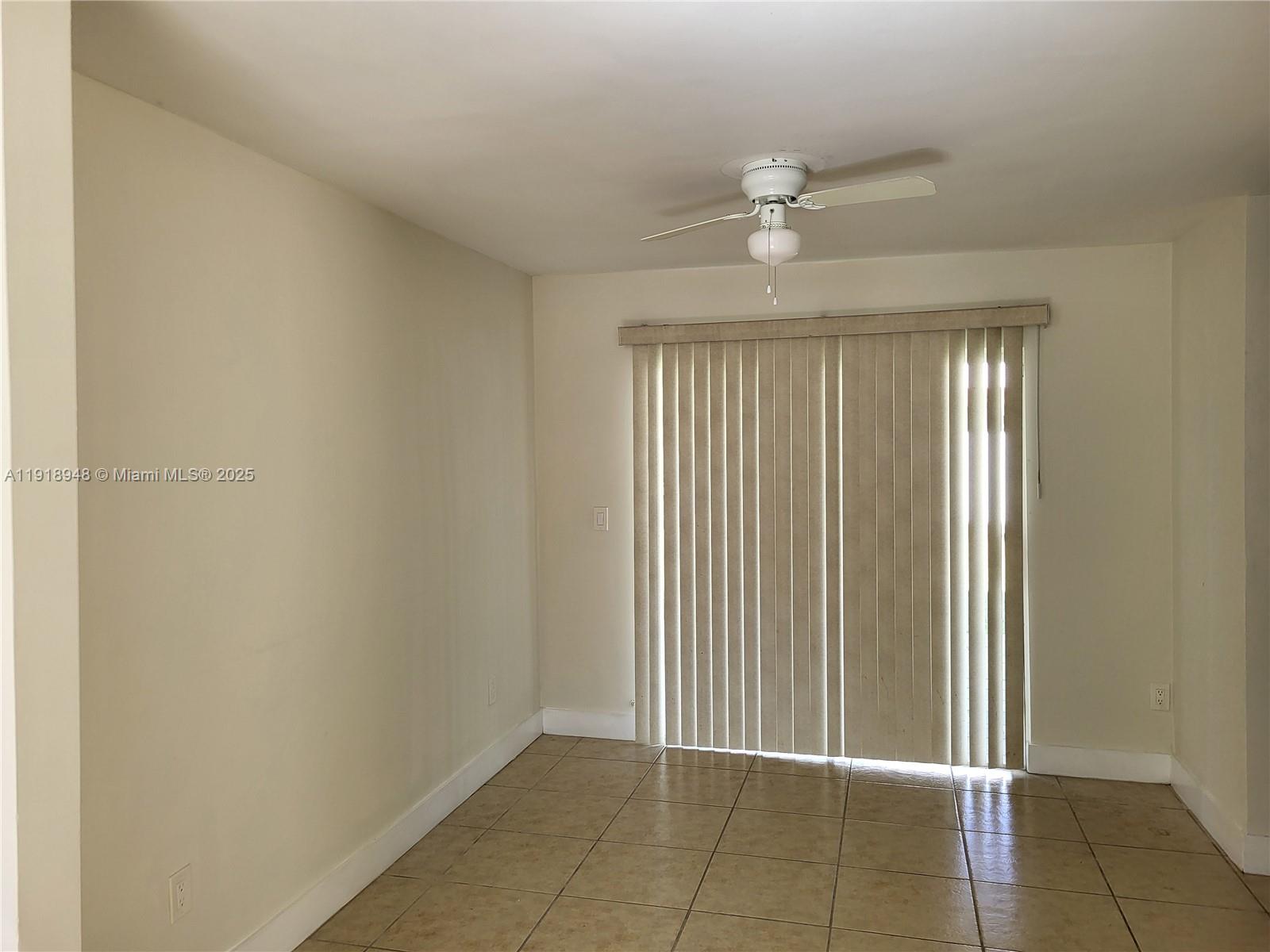 12309 Southwest 250th Street Homestead, FL 33032 - Photo 5 of 26 an empty room with windows and fan