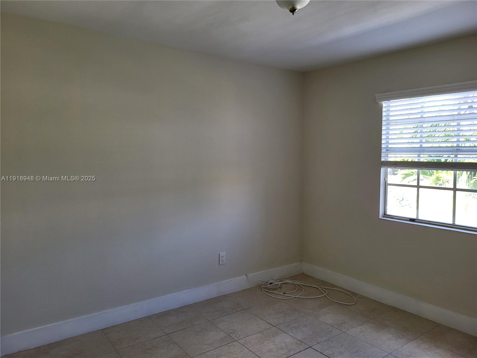12309 Southwest 250th Street Homestead, FL 33032 - Photo 9 of 26 an empty room with a window