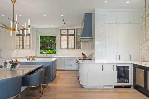 a kitchen with stainless steel appliances granite countertop a sink a stove and a refrigerator