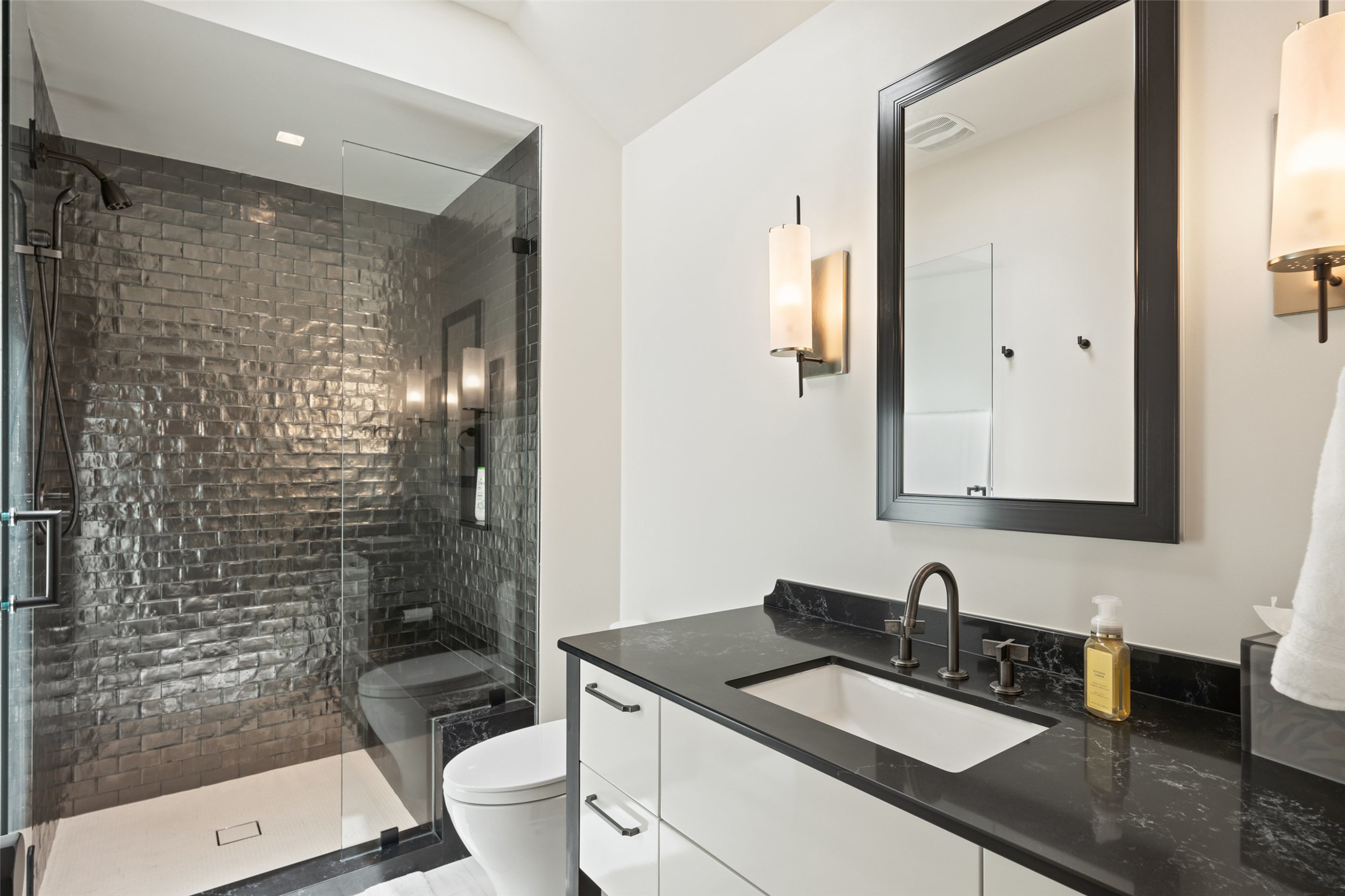 3111 Above Stratford Place Austin, TX 78746 - Photo 27 of 40 a bathroom with a granite countertop sink a toilet a mirror and shower