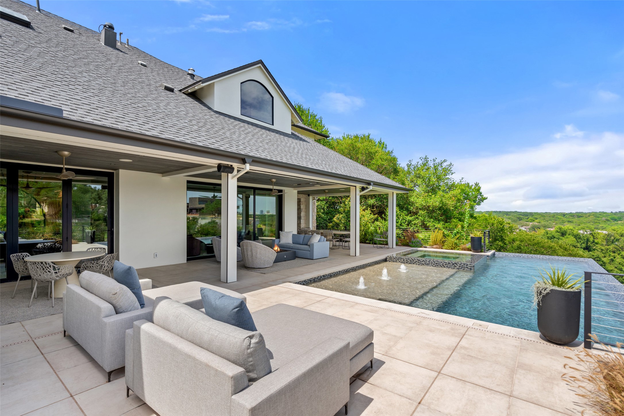 3111 Above Stratford Place Austin, TX 78746 - Photo 32 of 40 a view of a patio with couches and table and chairs with wooden fence