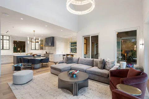 a front view of a house with garden and trees