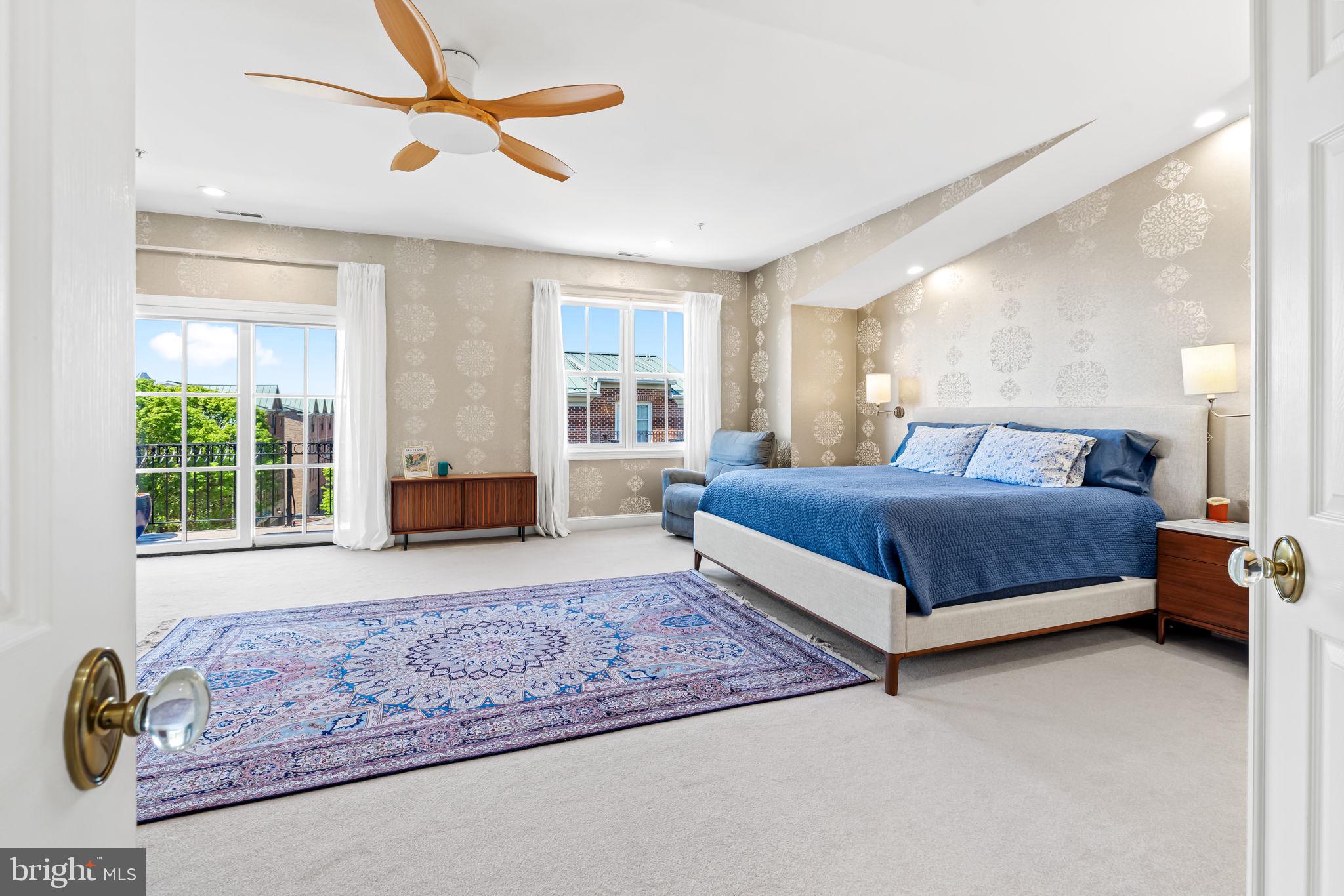 2331 Boston Street, Unit 1 Baltimore, MD 21224 - Photo 49 of 74 a bedroom with a large bed a chandelier and windows