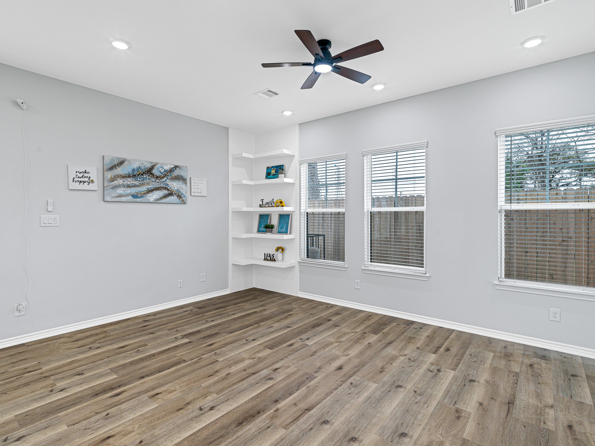 2720 Spence Street Houston, TX 77093 - Photo 16 of 30 a view of a big room with wooden floor and windows