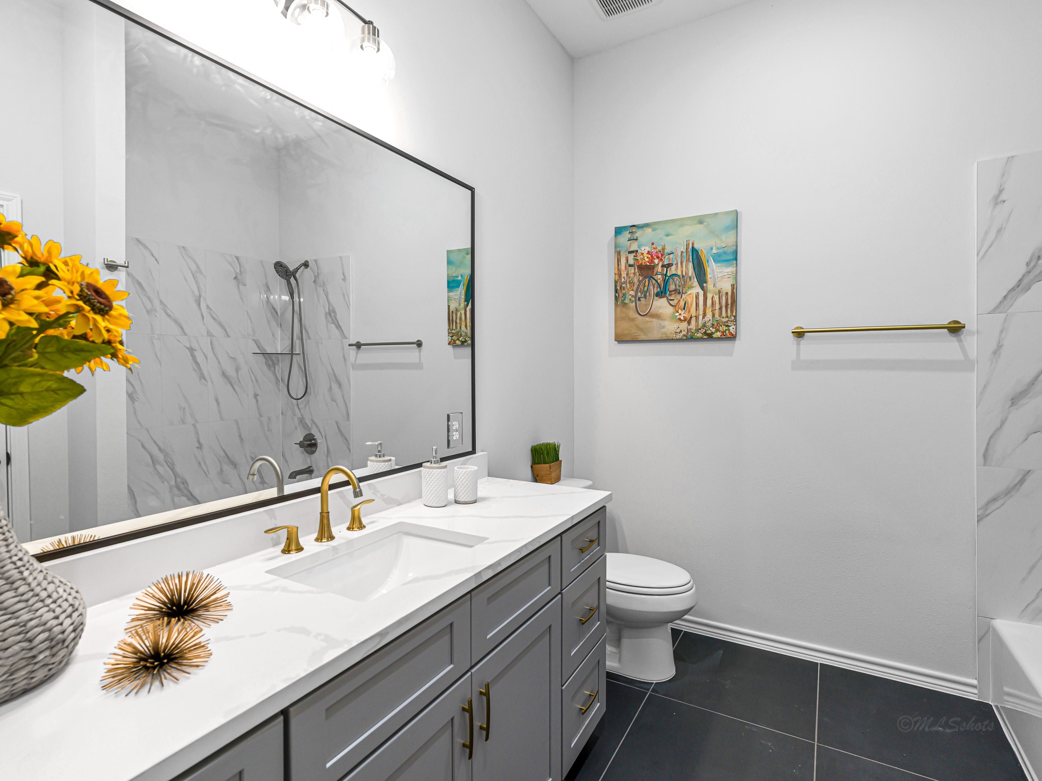 2720 Spence Street Houston, TX 77093 - Photo 28 of 30 a bathroom with a granite countertop sink a toilet and a mirror