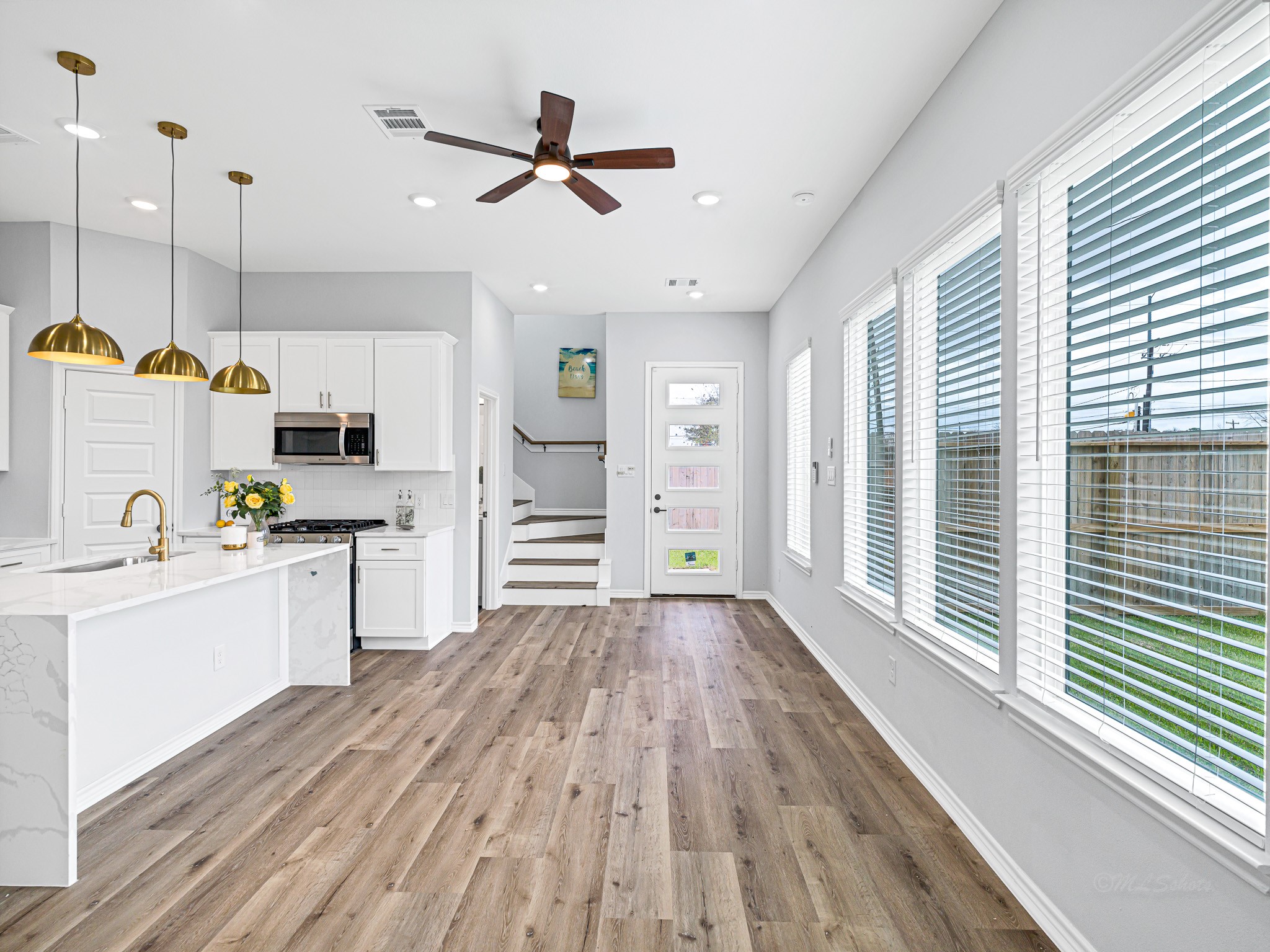 2720 Spence Street Houston, TX 77093 - Photo 9 of 30 a kitchen with cabinets wooden floor and a window