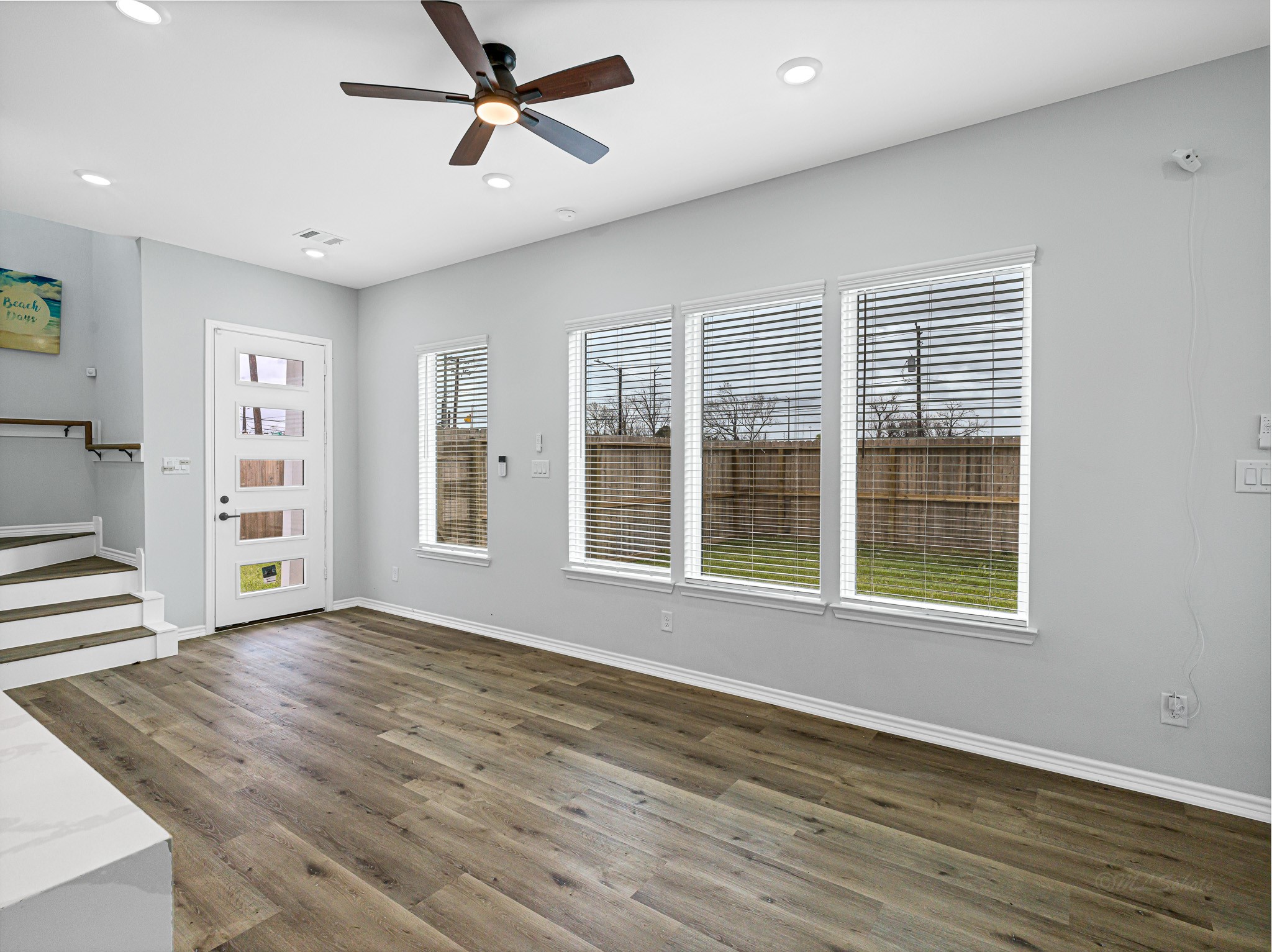 2720 Spence Street Houston, TX 77093 - Photo 10 of 30 an empty room with wooden floor and windows