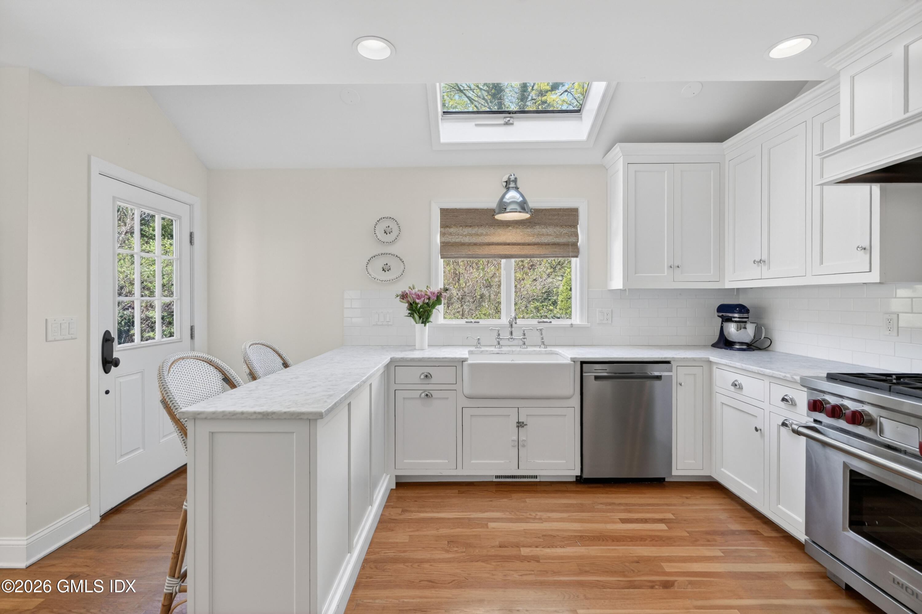 20 Ridge Road Cos Cob, CT 06807 - Photo 17 of 36 a white kitchen with a sink stove and cabinets