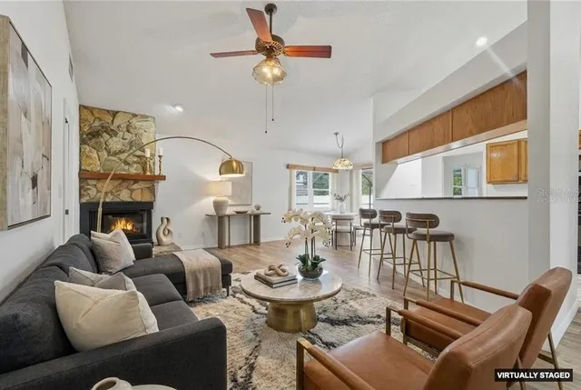 an empty room with windows and fireplace