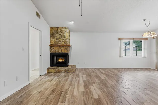 a dining room with furniture potted plants and wooden floor