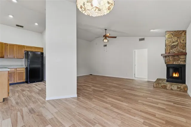 a view of a refrigerator in kitchen and a window