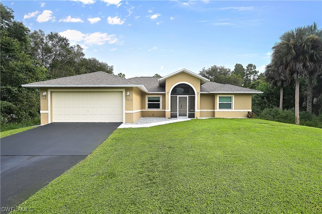 3535 18th Avenue Southeast Naples, FL 34117 - Photo 1 of 32 a front view of a house with garden