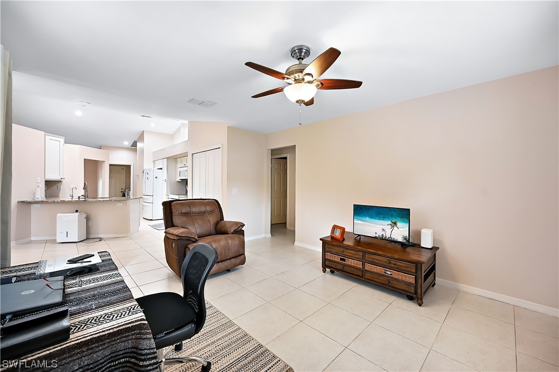 3535 18th Avenue Southeast Naples, FL 34117 - Photo 11 of 32 a living room with furniture and a rug
