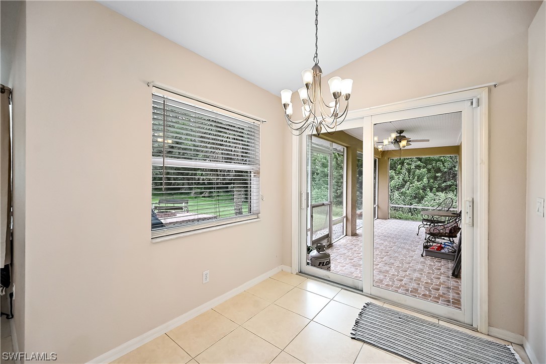 3535 18th Avenue Southeast Naples, FL 34117 - Photo 12 of 32 a view of a livingroom with a chandelier wooden floor and windows