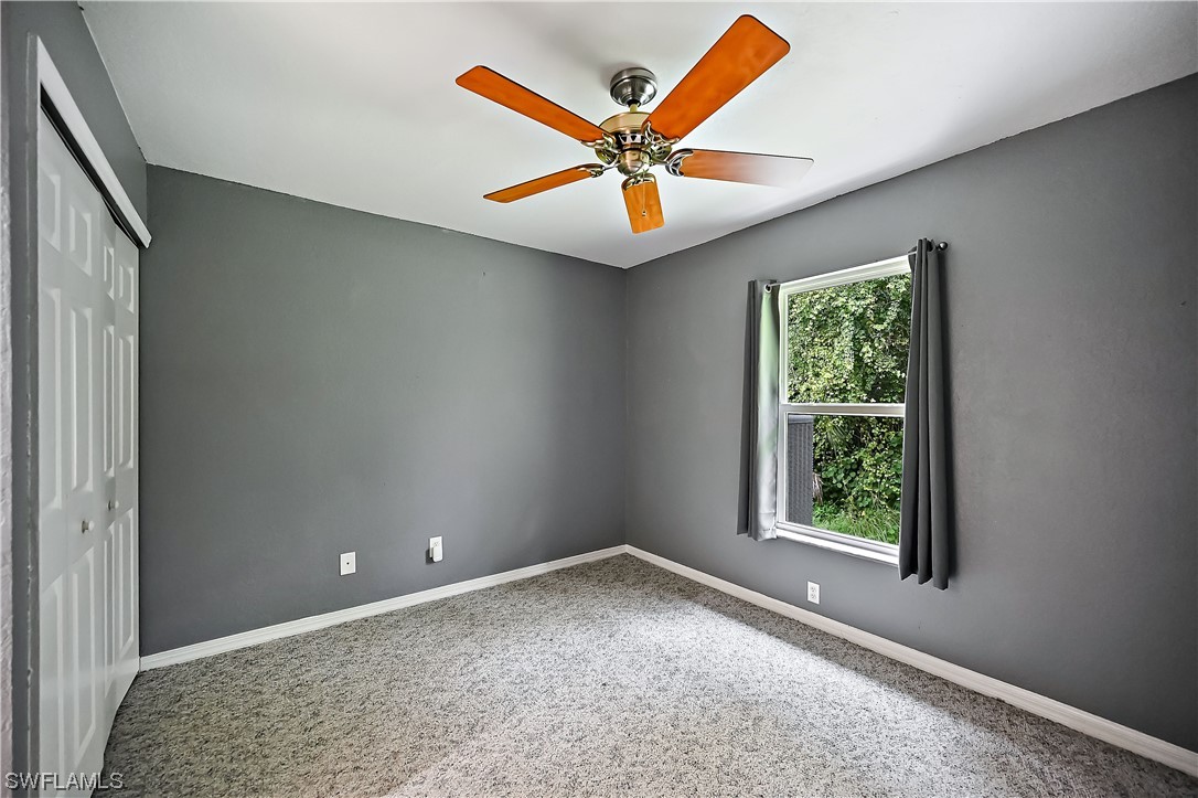 3535 18th Avenue Southeast Naples, FL 34117 - Photo 13 of 32 an empty room with ceiling fan and window