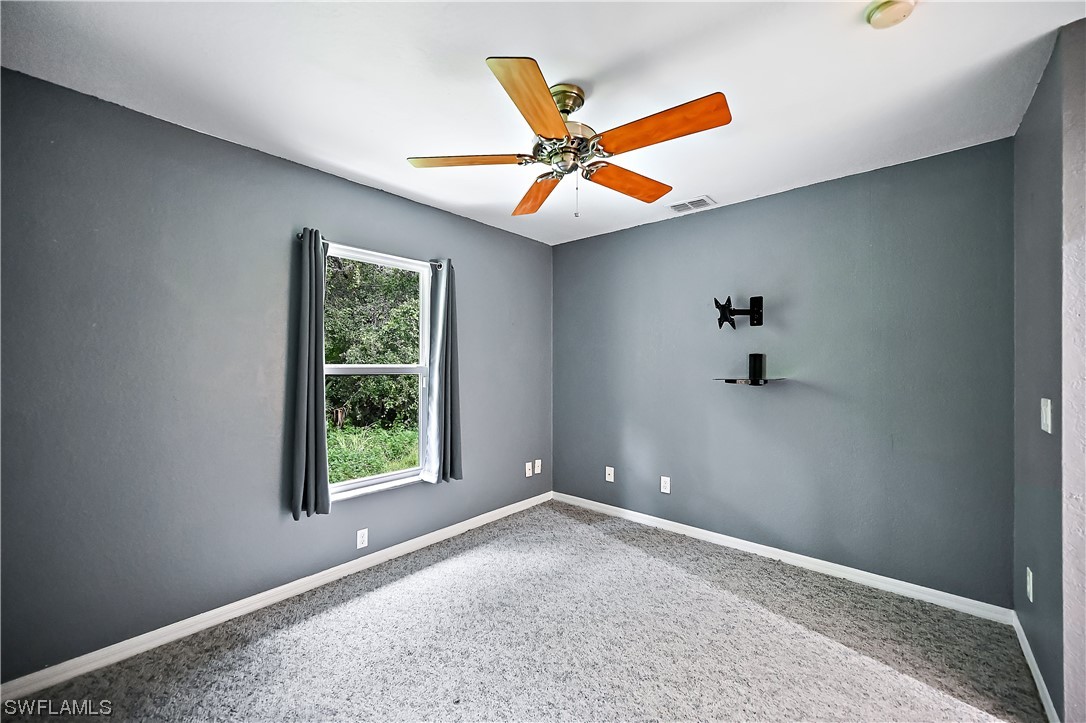 3535 18th Avenue Southeast Naples, FL 34117 - Photo 14 of 32 an empty room with windows and fan