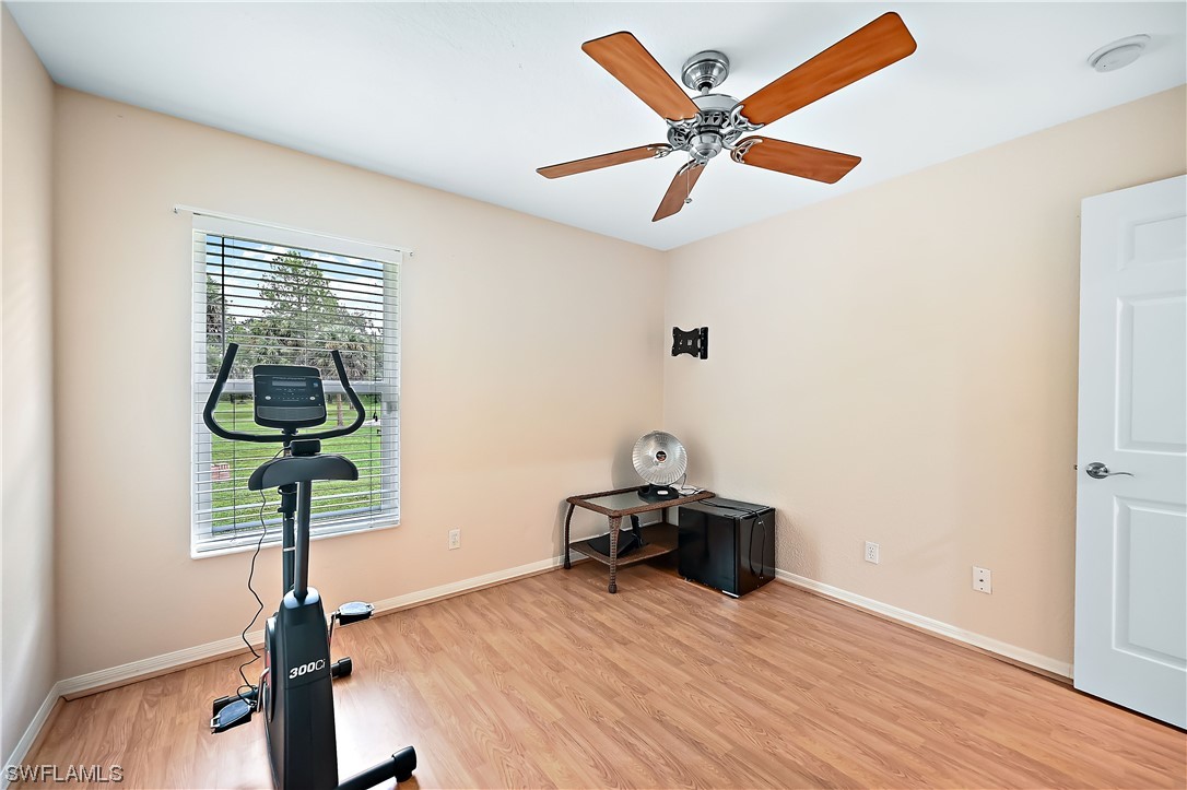 3535 18th Avenue Southeast Naples, FL 34117 - Photo 19 of 32 a room with ceiling fan and wooden floor