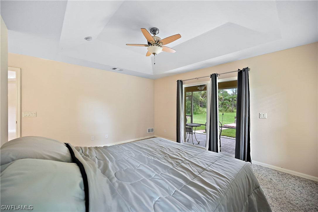 3535 18th Avenue Southeast Naples, FL 34117 - Photo 22 of 32 a bedroom with a large bed and a large window