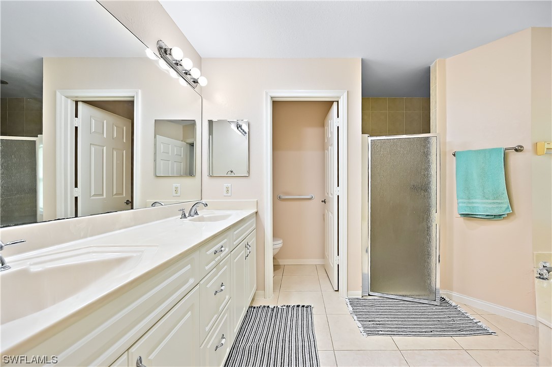 3535 18th Avenue Southeast Naples, FL 34117 - Photo 23 of 32 a spacious bathroom with a double vanity sink and a mirror