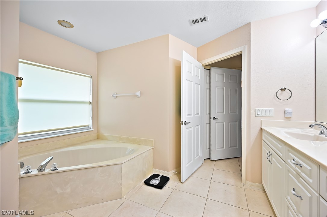 3535 18th Avenue Southeast Naples, FL 34117 - Photo 24 of 32 a bathroom with a tub sink and mirror