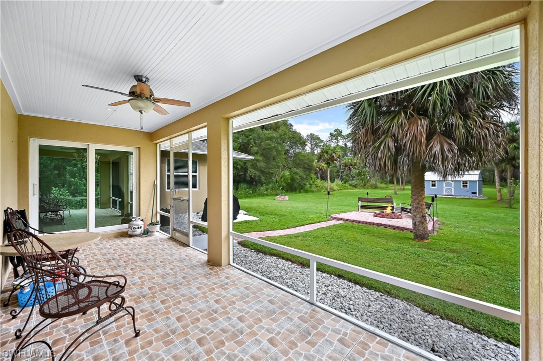 3535 18th Avenue Southeast Naples, FL 34117 - Photo 26 of 32 a view of a porch with furniture and yard
