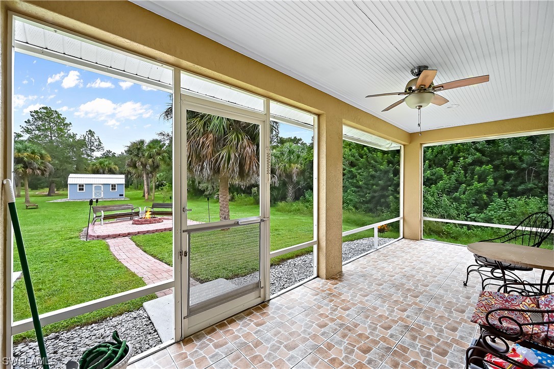 3535 18th Avenue Southeast Naples, FL 34117 - Photo 27 of 32 a view of a porch with furniture and yard