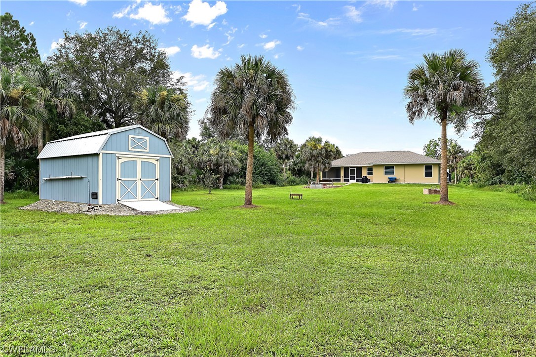 3535 18th Avenue Southeast Naples, FL 34117 - Photo 30 of 32 a front view of a house with garden