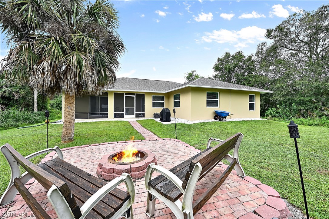 3535 18th Avenue Southeast Naples, FL 34117 - Photo 3 of 32 a view of house with backyard and outdoor seating