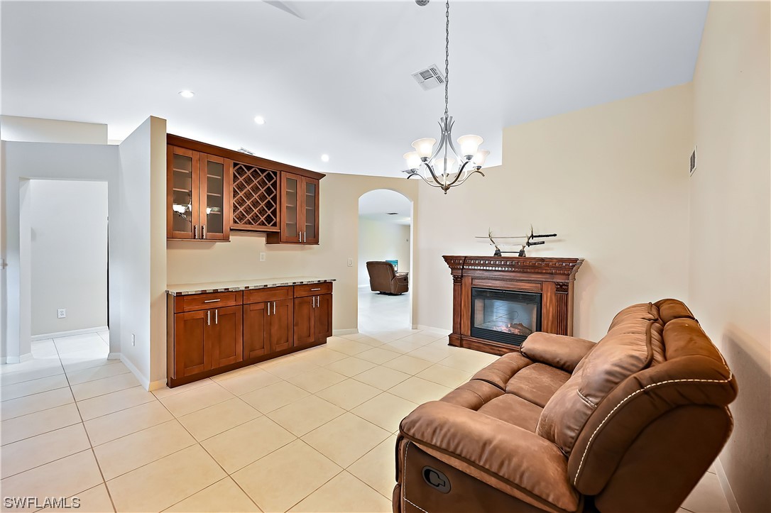 3535 18th Avenue Southeast Naples, FL 34117 - Photo 6 of 32 a living room with furniture and a chandelier
