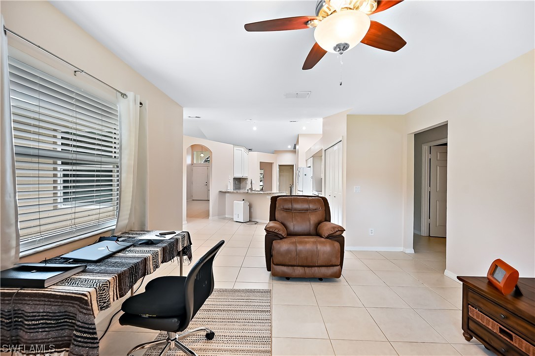 3535 18th Avenue Southeast Naples, FL 34117 - Photo 10 of 32 a living room with furniture and a window