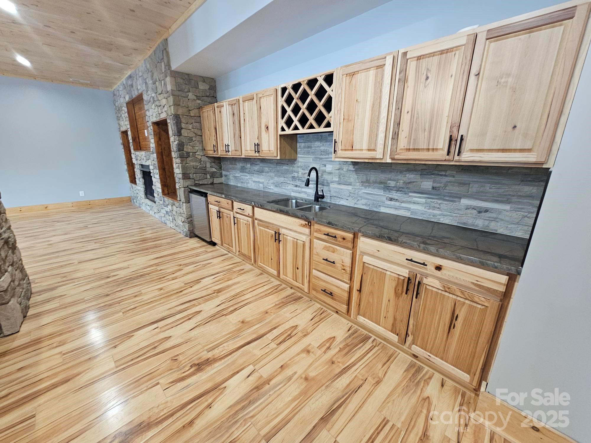 1076 Table View Drive, Unit 55 Morganton, NC 28655 - Photo 6 of 33 a kitchen with granite countertop a sink a stove top oven and cabinetry