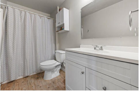 2116 24th Street Lubbock, TX 79411 - Photo 4 of 8 a bathroom with a sink toilet and shower