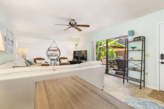 a living room with furniture a garden and a large window