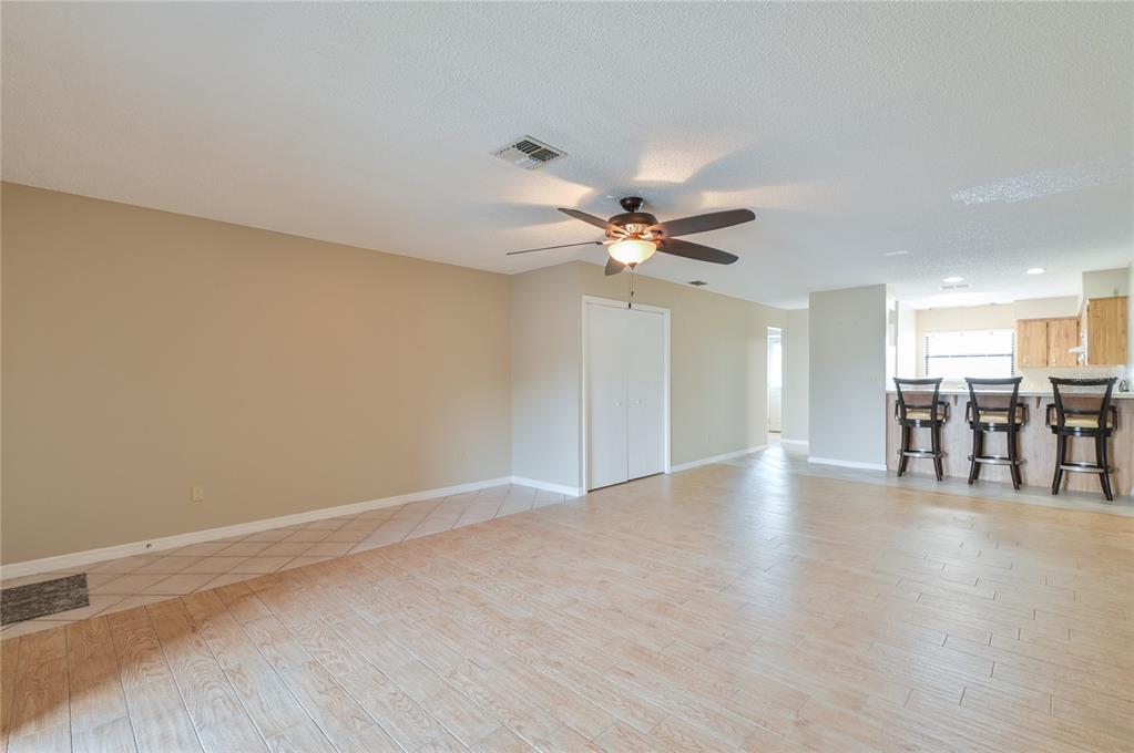 11001 Southeast Sunset Harbor Road, Unit H52 Summerfield, FL 34491 - Photo 8 of 31 a view of an empty room with wooden floor and a window