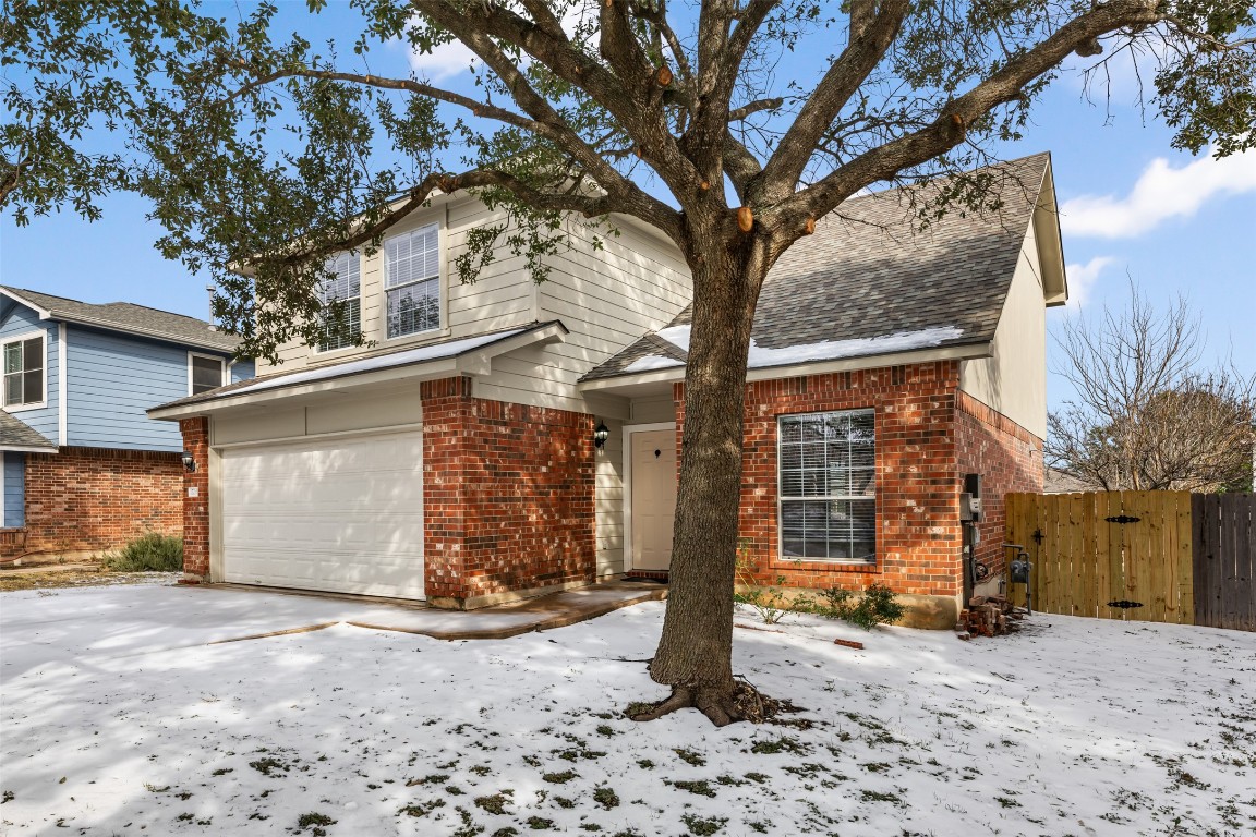 15216 Mandarin Crossing Pflugerville, TX 78660 - Photo 2 of 40 Traditional-style home with a garage, a gate, driveway, brick siding, and roof with shingles