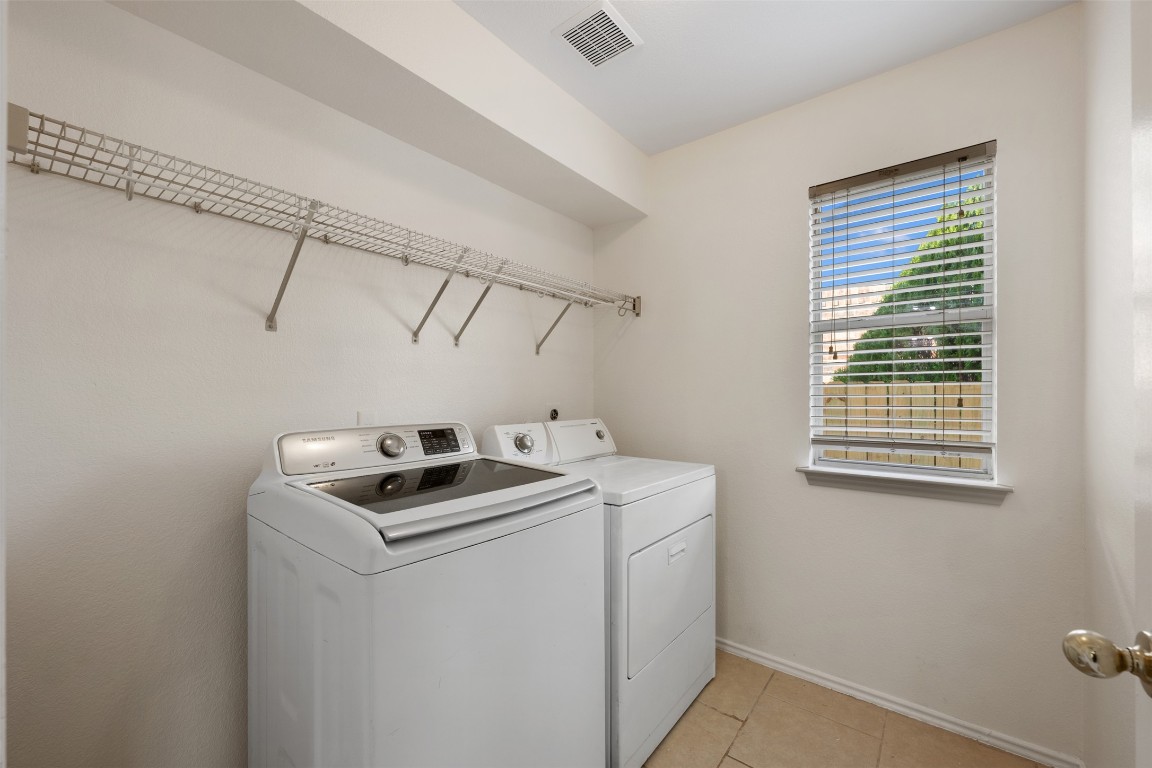 15216 Mandarin Crossing Pflugerville, TX 78660 - Photo 21 of 40 Washroom with light tile patterned floors and washing machine and clothes dryer