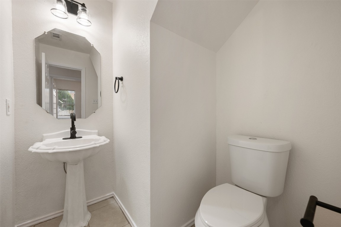 15216 Mandarin Crossing Pflugerville, TX 78660 - Photo 22 of 40 Bathroom with light tile patterned floors and lofted ceiling