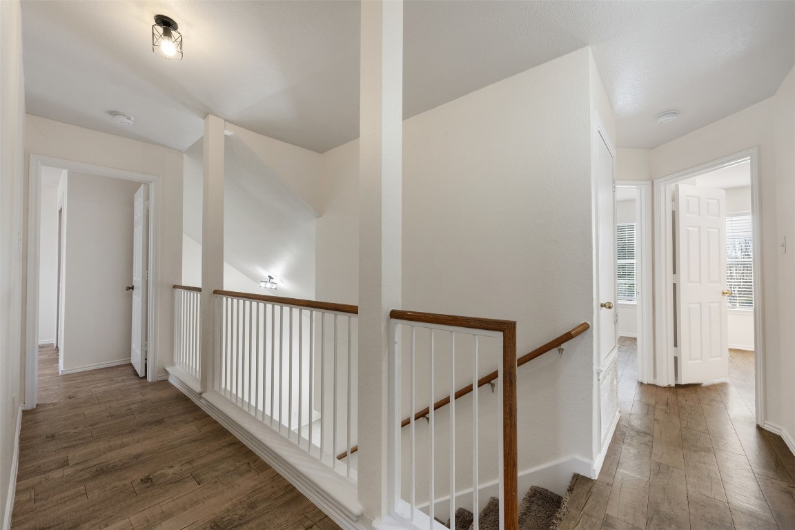 15216 Mandarin Crossing Pflugerville, TX 78660 - Photo 23 of 40 Corridor featuring dark wood finished floors and an upstairs landing