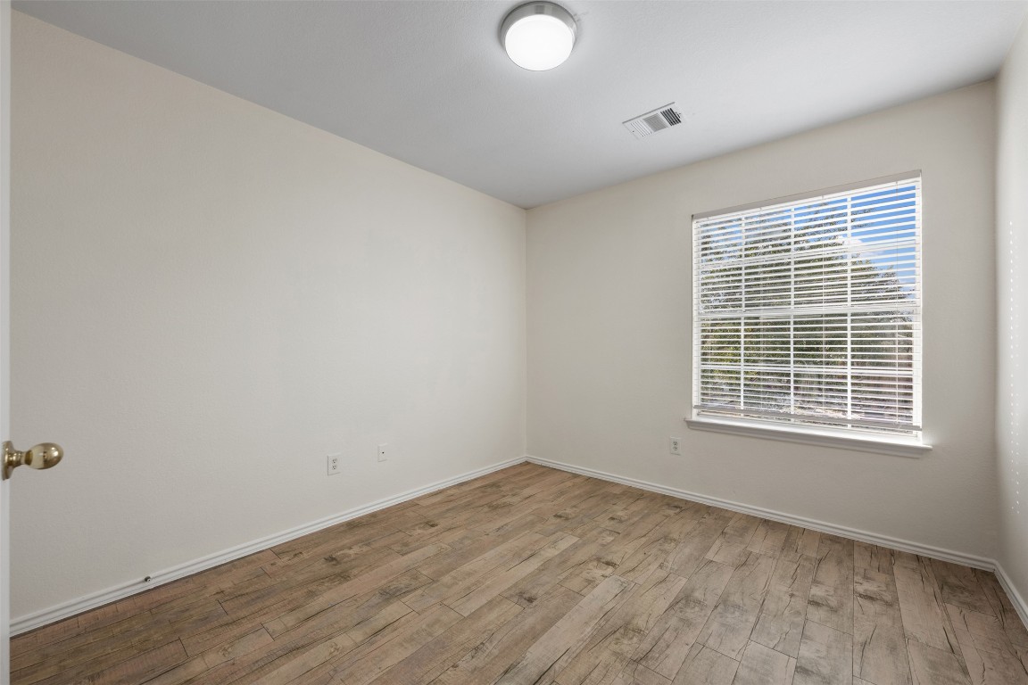 15216 Mandarin Crossing Pflugerville, TX 78660 - Photo 32 of 40 Unfurnished room featuring light wood-type flooring and baseboards