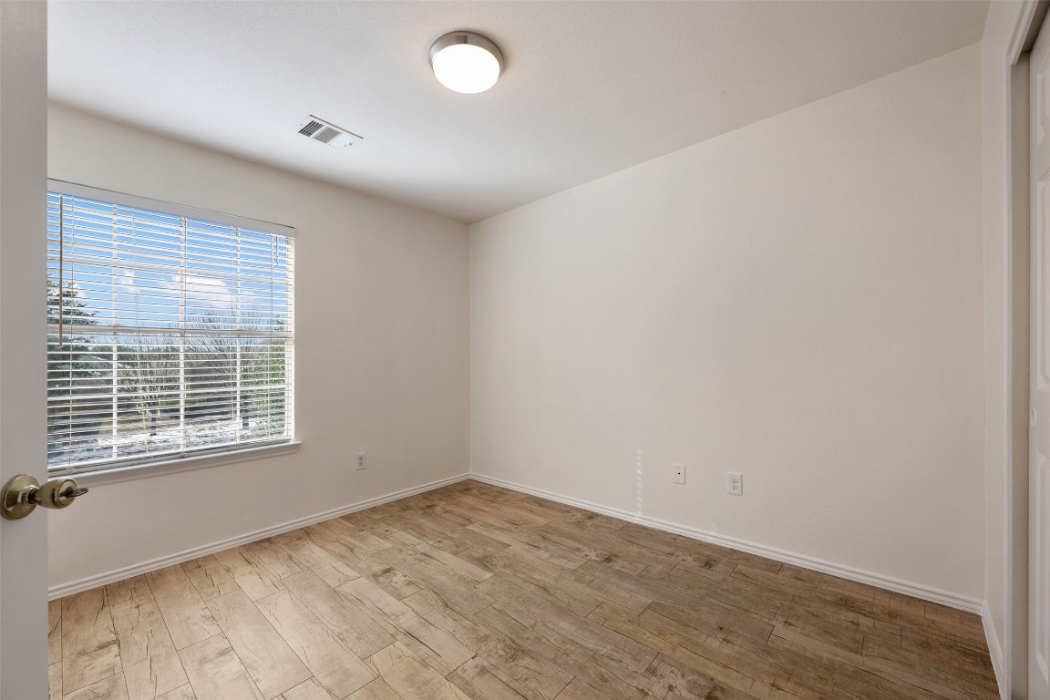 15216 Mandarin Crossing Pflugerville, TX 78660 - Photo 33 of 40 Unfurnished room featuring light wood-type flooring and baseboards