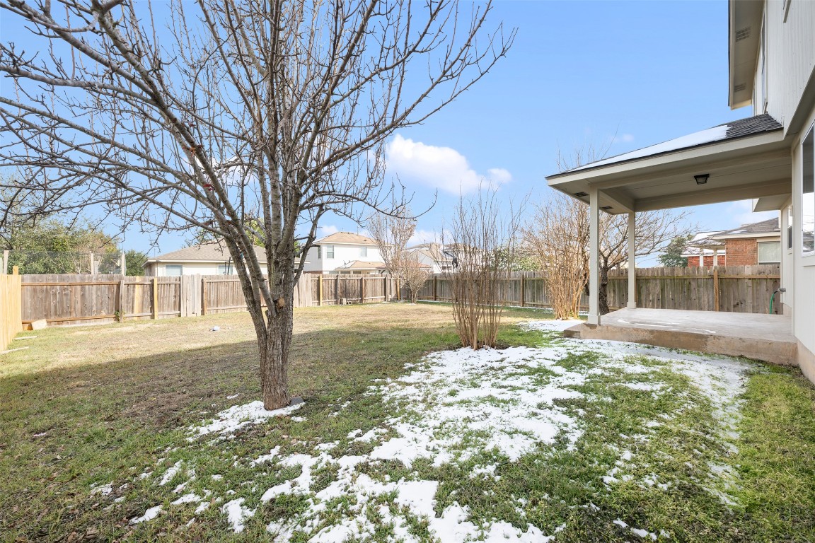 15216 Mandarin Crossing Pflugerville, TX 78660 - Photo 36 of 40 Yard covered in snow featuring a fenced backyard and a patio
