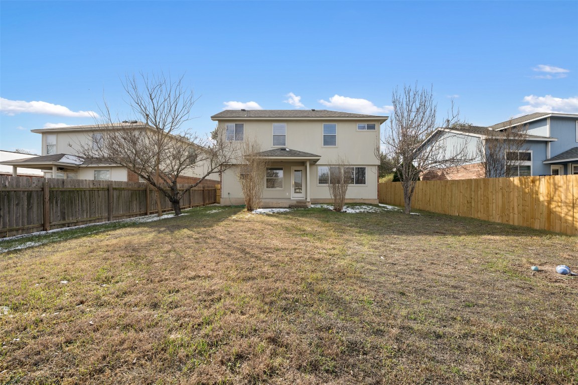 15216 Mandarin Crossing Pflugerville, TX 78660 - Photo 38 of 40 Rear view of house featuring a fenced backyard and a patio