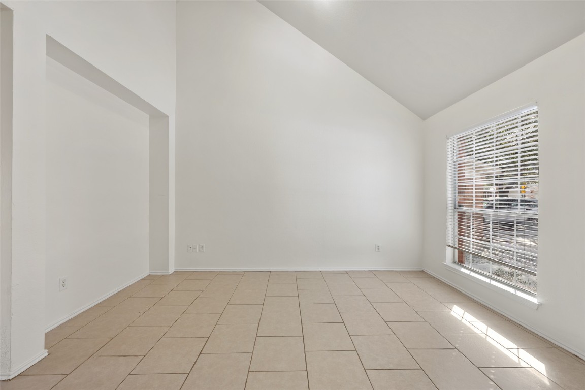 15216 Mandarin Crossing Pflugerville, TX 78660 - Photo 6 of 40 Unfurnished room featuring high vaulted ceiling and light tile patterned floors