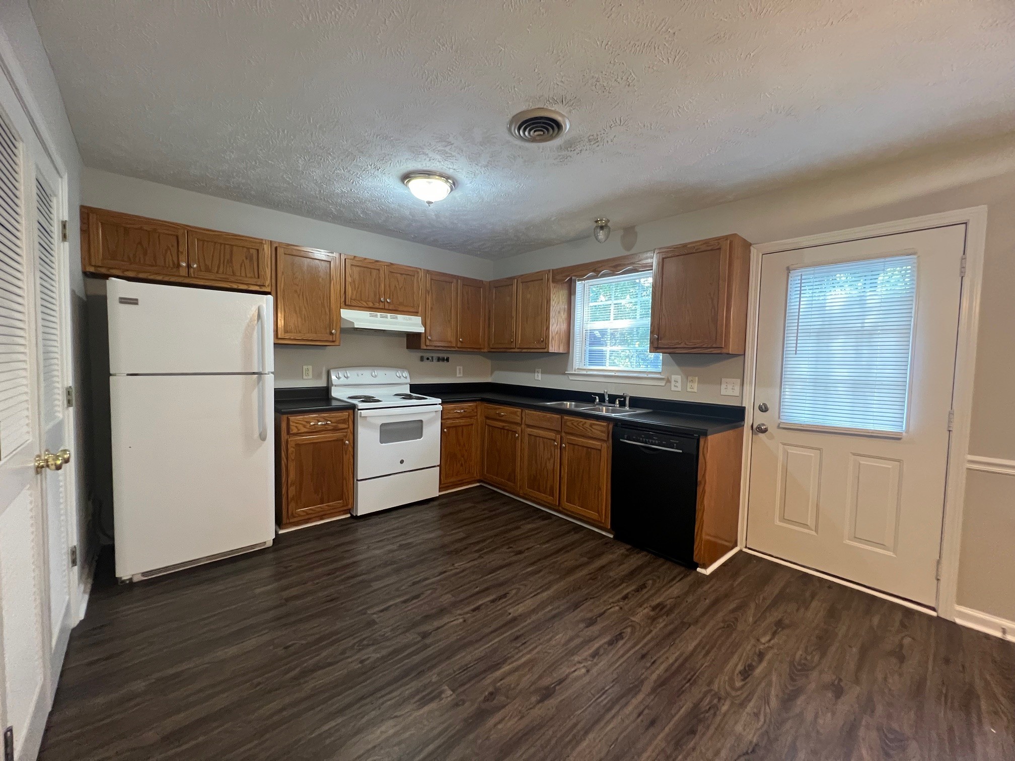 1512 Center Pointe Drive Murfreesboro, TN 37130 - Photo 6 of 18 a kitchen with wooden floors and white appliances