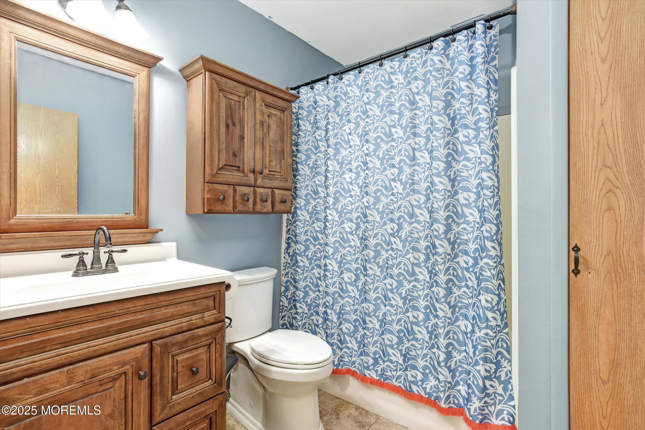 10 Bowman Road Jackson, NJ 08527 - Photo 17 of 32 a bathroom with a granite countertop toilet sink and mirror